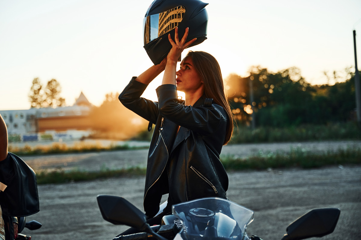 femme met son casque moto